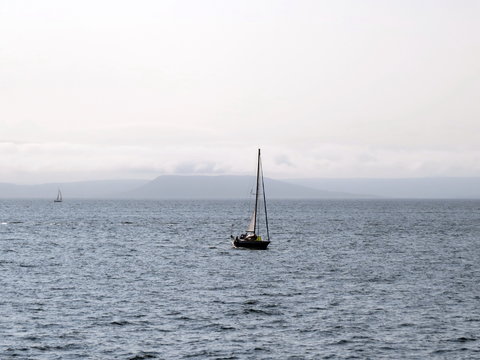 Fototapeta A yacht sailing under sail