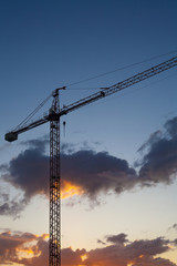 Construction site with crane at sunset