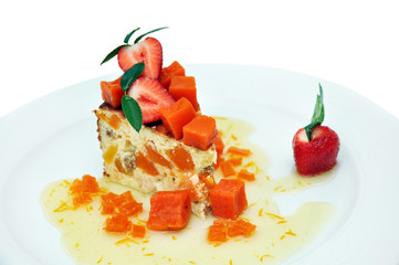 Cheesecake with pumpkin, decorated with strawberries and mint. A piece of cheesecake with pumpkin isolated on a white background.