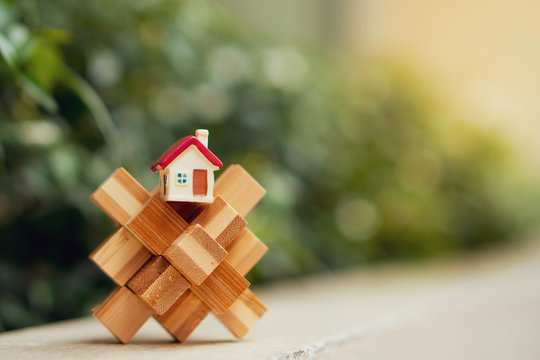 Miniature house on wooden cube using as property and concept - Vintage filter