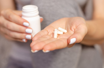 Woman sick in hands jar of pills medical pharmacy