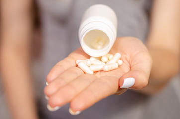 Woman sick in hands jar of pills medical pharmacy