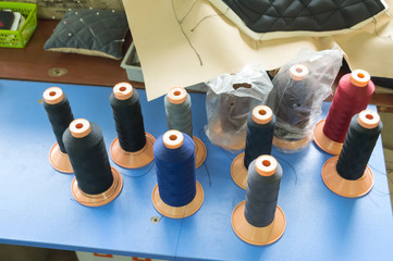 Bobbins with colored threads in the studio
