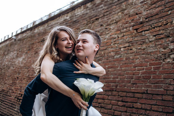 The lovely couple in love walking along narrow street