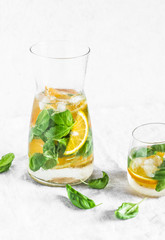 Orange basil  detox lemonade on a light background. Vegetarian, diet, weight loss, summer drink concept