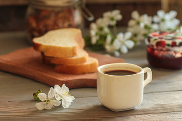 black coffee in a white cup and flowers (portion of hot coffee)