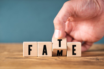 Hand flips a cube with letters and turns the word 
