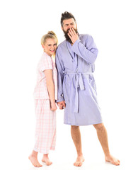 Couple, family on smiling faces in clothes for sleep looks sleepy in morning. Couple in love in pajama, bathrobe. Good morning concept. Couple hold hands together, isolated on white background.