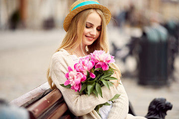 Young blonde girl with pink flowers and hat