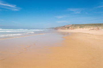 Fototapeta na wymiar Footprints on a huge, empty beach, on the Atlantic Ocean