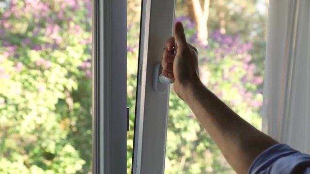 hand open plastic pvc window at home