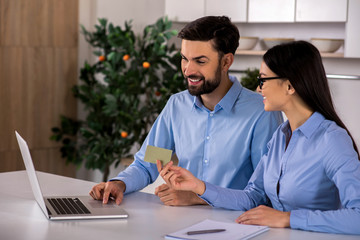 Smiling business colleagues using online banking system