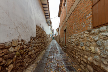 Narrow passage with cobblestone in the San Blas neighborhood of Cusco, Peru