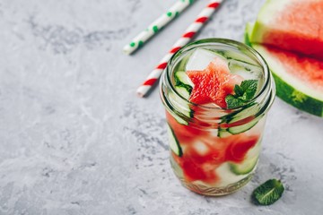 Infused detox water with watermelon, cucumber slices and mint. Ice cold summer cocktail or lemonade