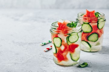 Infused detox water with watermelon, cucumber slices and mint. Ice cold summer cocktail or lemonade