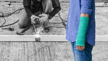 Accident on arm, green cast on hand and arm isolated on asian worker with machine cutting metal and welded steel to create a roof, insurance concept - Powered by Adobe