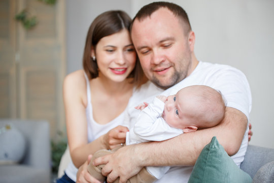 Picture of cuddling parents with newborn son