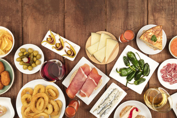 Spanish tapas food on dark background with wine and copy space