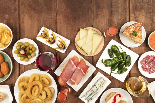 Spanish tapas food on dark background with wine and copy space