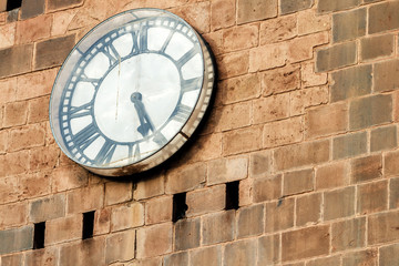 Close-up of clock with Roman numerals on the stone wall of the Cathedral of Cusco (Peru)