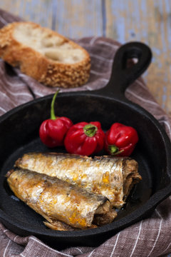 Canned fish and peppers on pan