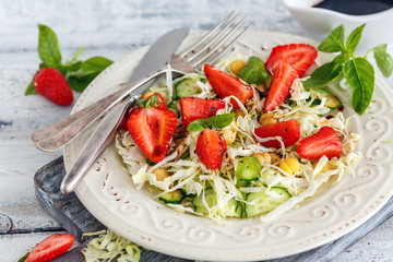 Salad with fresh strawberries and balsamic sauce.