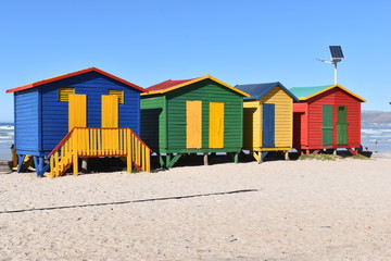 Obraz na płótnie Canvas Colorful bathing cabins on the beach in Muizenberg in Cape Town, South Africa