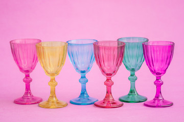 Row of Multi Colored Glasses on Pink