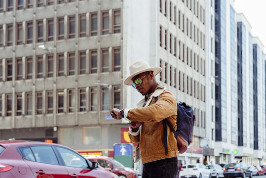 Black Man In Glasses Looking On Watch