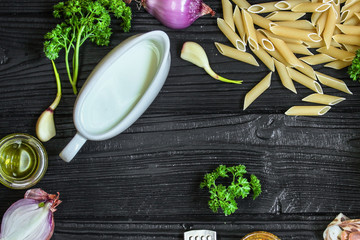 Fototapeta na wymiar pasta penne and ingredients for creamy sauce with cheese - (meal) - cuisine. Food background