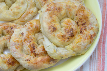Baked snack with stuffing with golden crust. Traditional moldavian food called platzinda