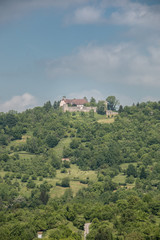 Little village in the middle of the german countryside with forests, fields and meadows