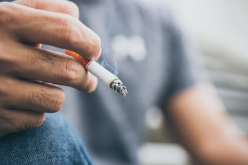 Asian stress handsome man smoking,Thailand people,Depressed man concept,He worry about work of...