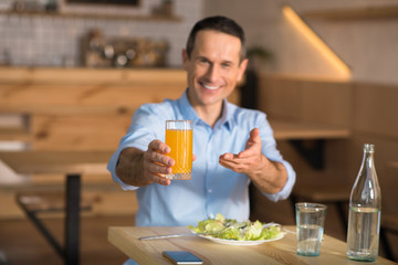 Fototapeta na wymiar businessman holding glass of orange juice