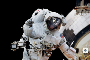 Close up of an astronaut waving hi to the camera.Elements of this image furnished by NASA.