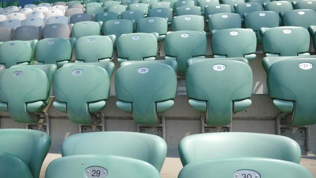 Empty football stadium rows and seats without people and fans slow motion glide camera