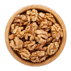 Peeled walnuts in wooden bowl isolated on white. Top view.