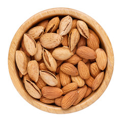 Almond in wooden bowl isolated on white. Top view.