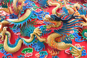 chinese dragon statue at the wall of temple in Thailand
