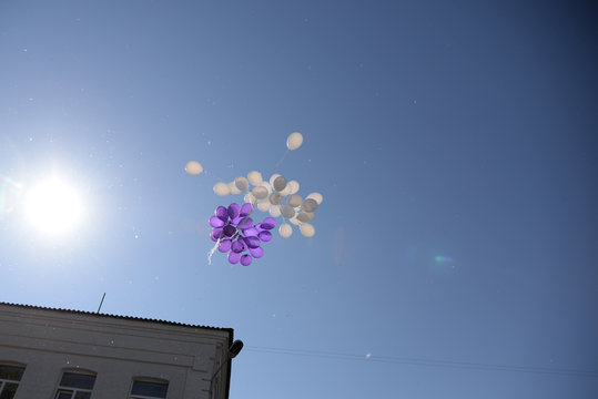 White and purple balls flying to the sky
