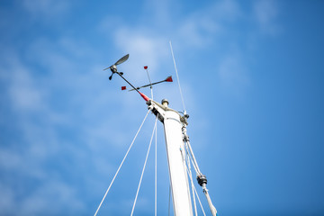 Mast of a white sailing yacht against the blue sky