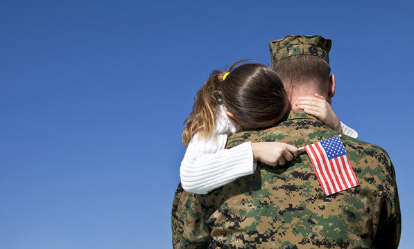 Military Father Hugging His Daughter With An American Flag
