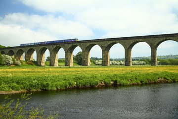 Fototapeta na wymiar Arthington to castley railway viaduct spanning the river wharfe in leeds west yorkshire with a commuter train on the line