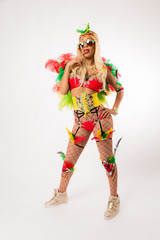 Tall blonde black woman in Carnaval costume and athletic shoes posing on clean white background