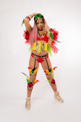 Fit young asian woman in Carnaval costume and athletic shoes posing on clean white background