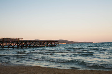 Obraz premium Wooden pier on the sea at sunset.