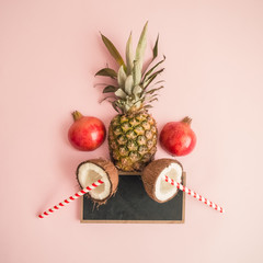 Creative layout of fresh fruits on rose background abstract.