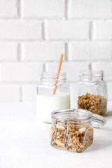 Granola and dessert of cereals and yogurt in a glass jar, Healthy food concept on a light background