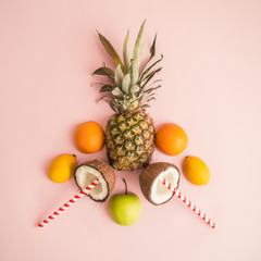 Creative layout of fresh fruit slices on rose background abstract.