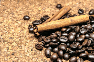 Fresh black coffe beans on cork table